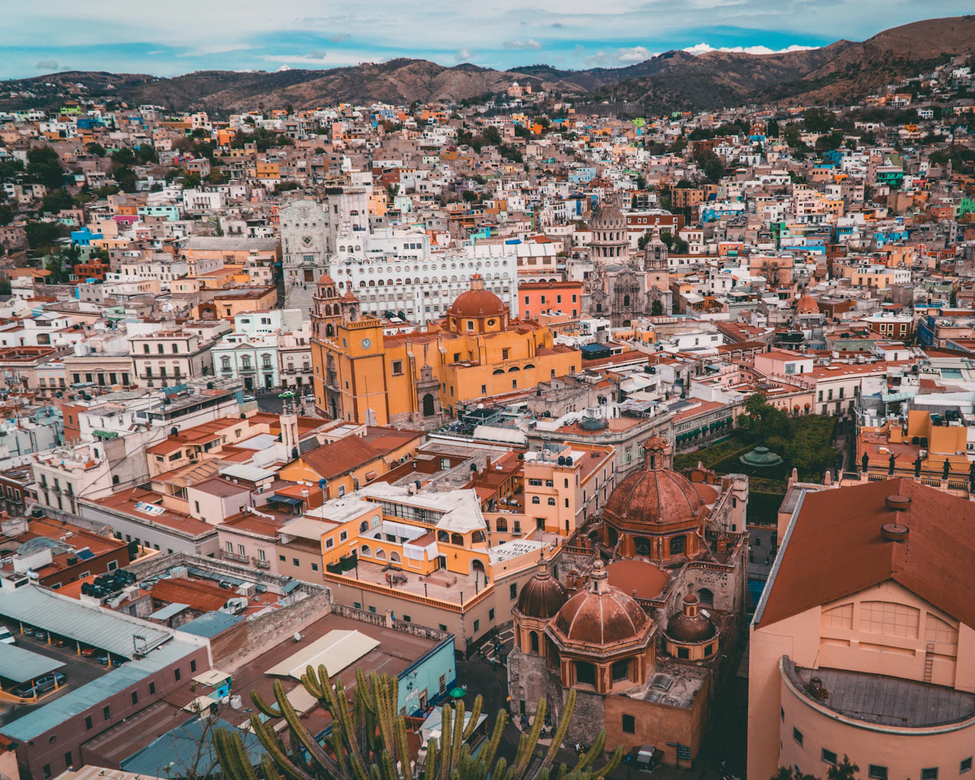 Vista aérea del centro histórico de Guanajuato, con la Basílica amarilla y cúpulas de cantera entre casas de colores